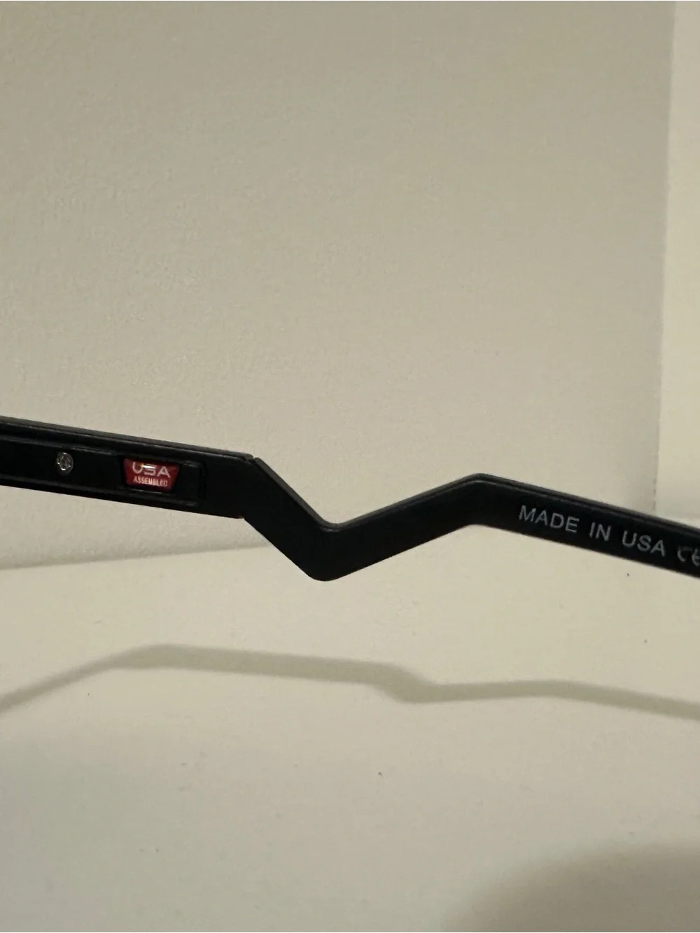 Oakley Black Round Sunglasses with Zigzag Temples and White Logo Accents